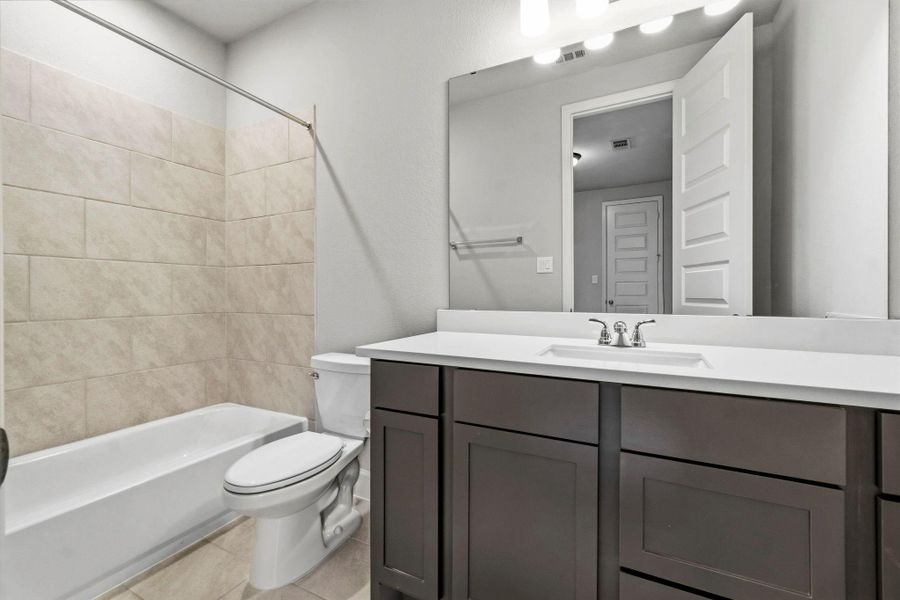 A third full bathroom upstairs provides added convenience for the secondary bedrooms, game room, and media room.