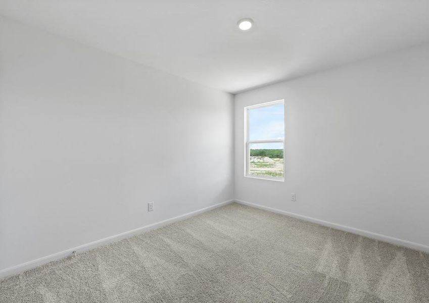 A secondary bedroom with carpet