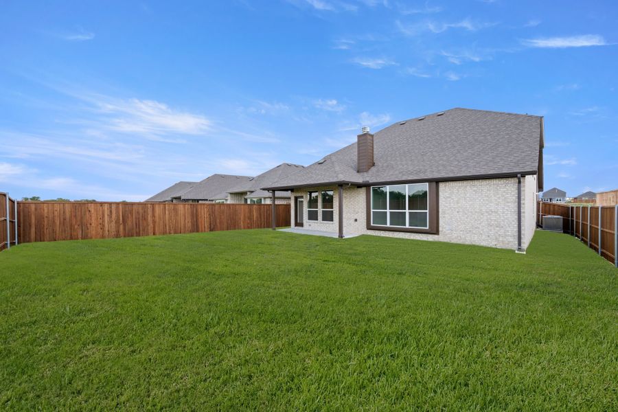 Exterior details and patio area of a home in Meadow Park at The Meadows, Ponder (Image 20).