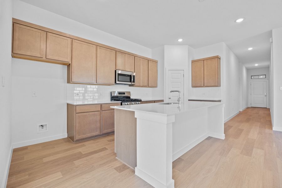 Kitchen in the Quartz home plan by Trophy Signature Homes – REPRESENTATIVE PHOTO