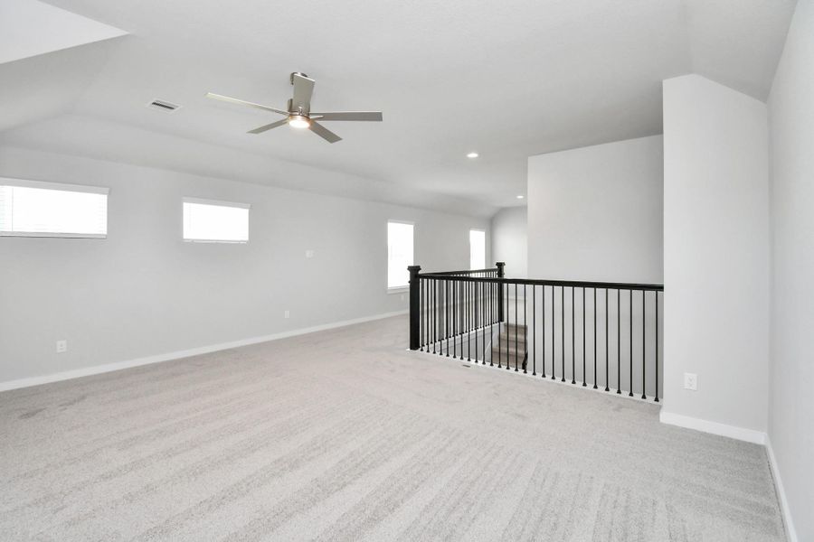 Come upstairs and enjoy a day of leisure in this fabulous game room! This is the perfect hangout spot or adult game room! Features plush carpet, high ceilings, custom paint and windows for plenty of natural light. Sample photo of completed home with similar floor plan. Actual colors and selections may vary. Come upstairs and enjoy a day of leisure in this fabulous game room! This is the perfect hangout spot or adult game room! Features plush carpet, high ceilings, custom paint and windows for plenty of natural light. Sample photo of completed home with similar floor plan. Actual colors and selections may vary.