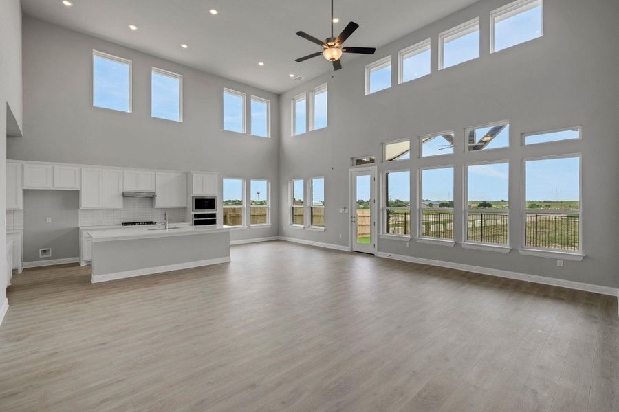 Unfurnished living room with a ceiling fan, light wood-type flooring, and recessed lighting Unfurnished living room with a ceiling fan, light wood-type flooring, and recessed lighting