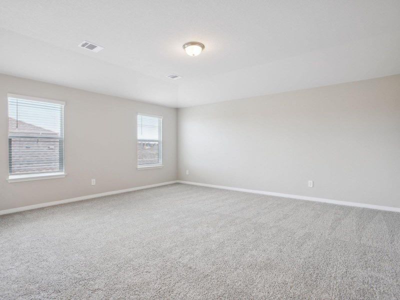 Carpeted spare room featuring baseboards Carpeted spare room featuring baseboards