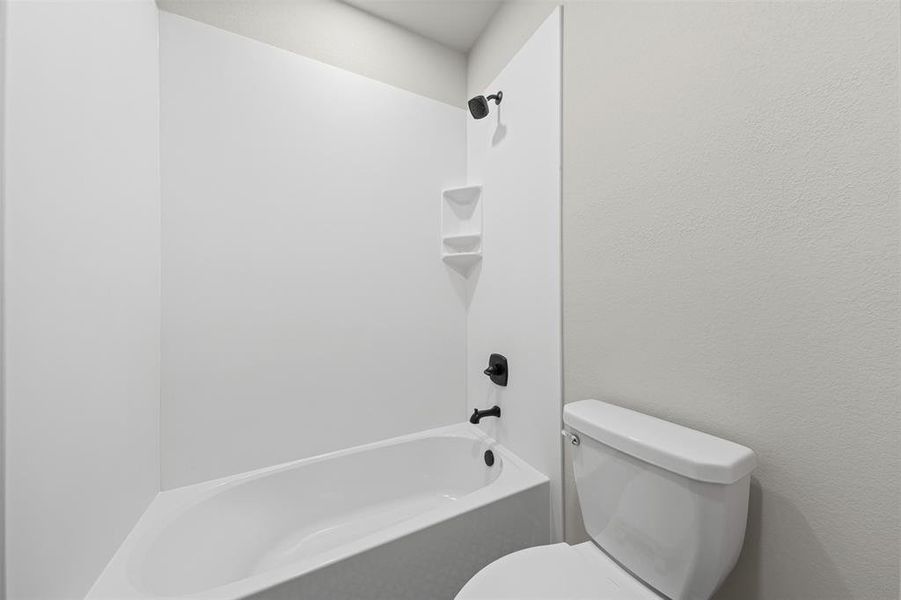 Bathroom featuring  shower combination and toilet