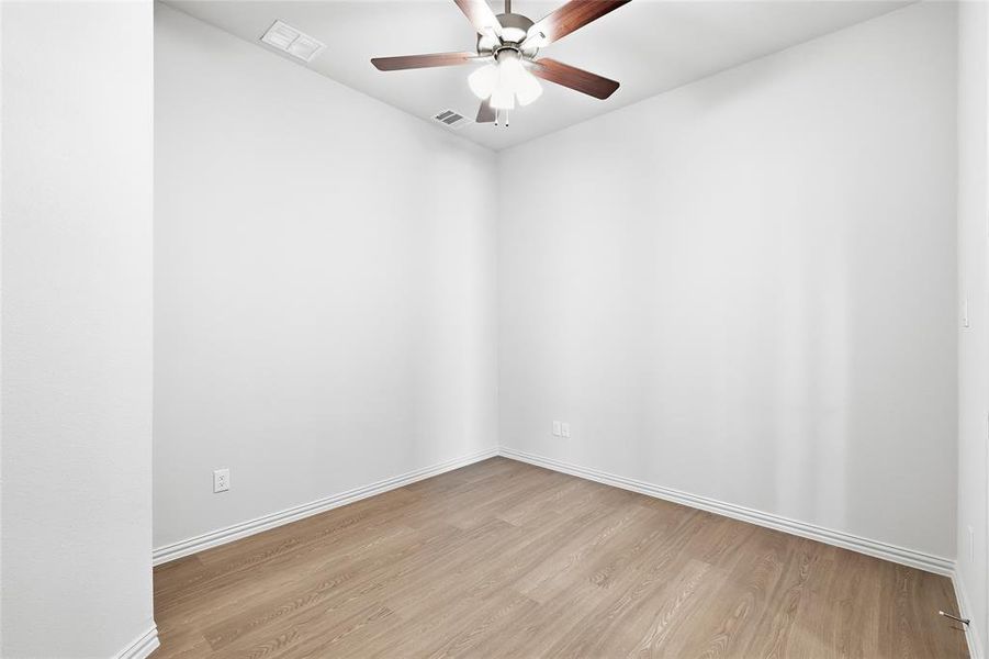 Spare room featuring light wood-style floors and ceiling fan