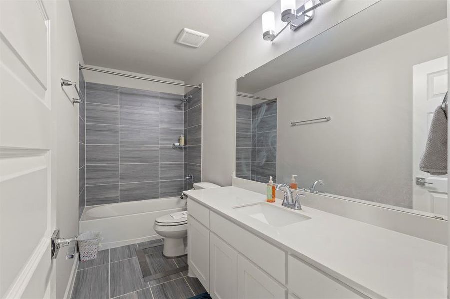 Bathroom with vanity and bathing tub / shower combination