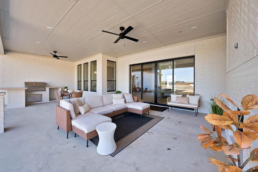 View of patio / terrace with exterior kitchen, a ceiling fan, and outdoor lounge area