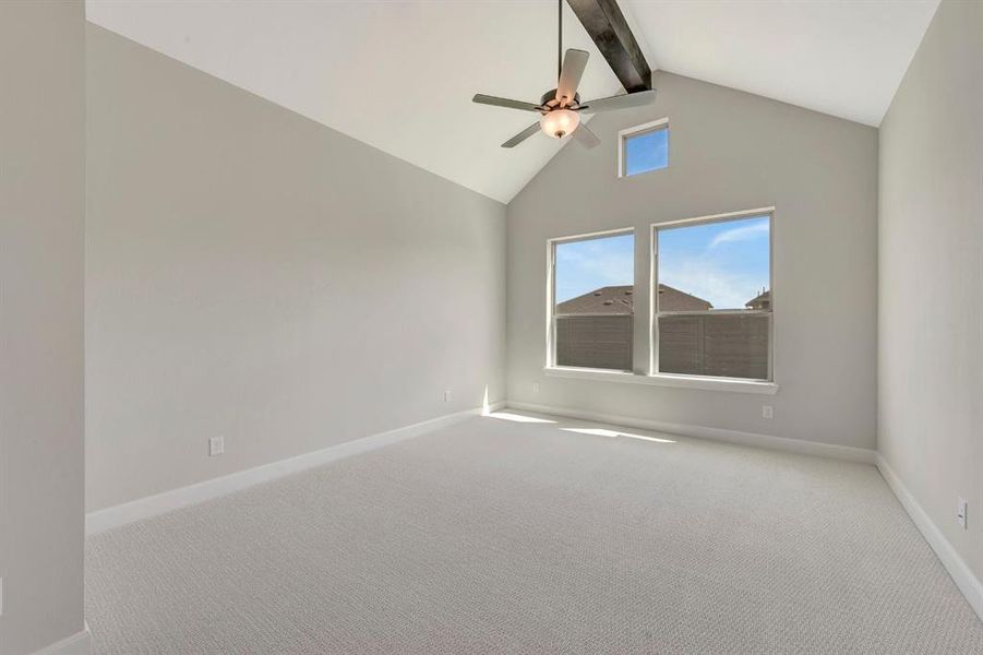 Vaulted ceiling with an exposed beam and ceiling fan