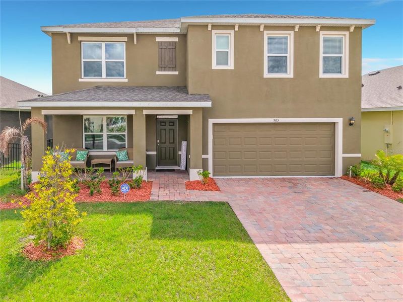 Front exterior of a new home in Cypress Bay West, Palm Bay, FL, highlighting curb appeal (Image 26).