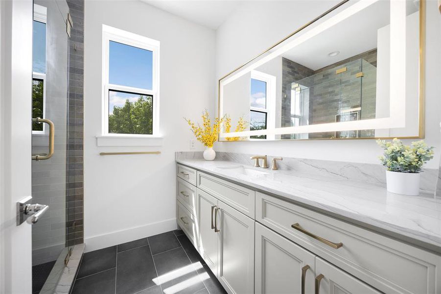 Full bathroom featuring vanity, tile patterned floors, and a tile shower Full bathroom featuring vanity, tile patterned floors, and a tile shower