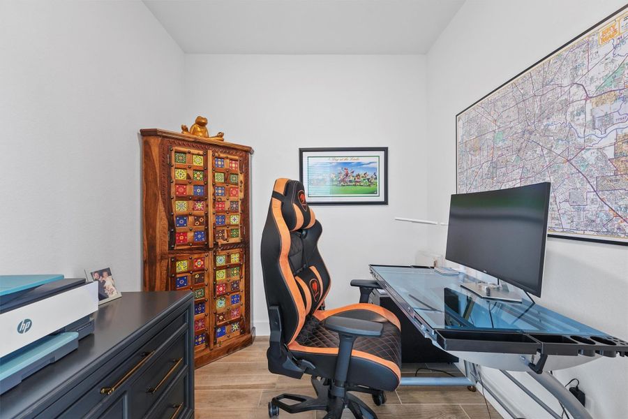 This private and functional home office is located just off the entryway, providing a quiet space for remote work or study. The room is perfect for maintaining productivity while still being a part of the home's main living area.