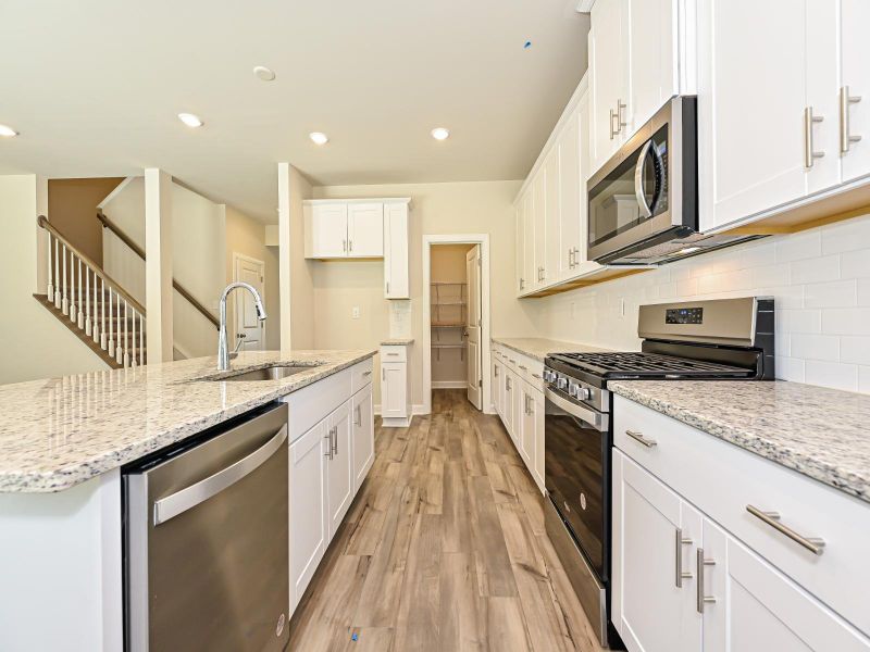 Prepare meals at the kitchen island while the kids hangout in the living area.