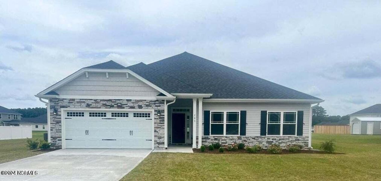 Front exterior of a new home in Summer Place, Grimesland, NC, highlighting curb appeal (Image 1). Front exterior of a new home in Summer Place, Grimesland, NC, highlighting curb appeal (Image 1).