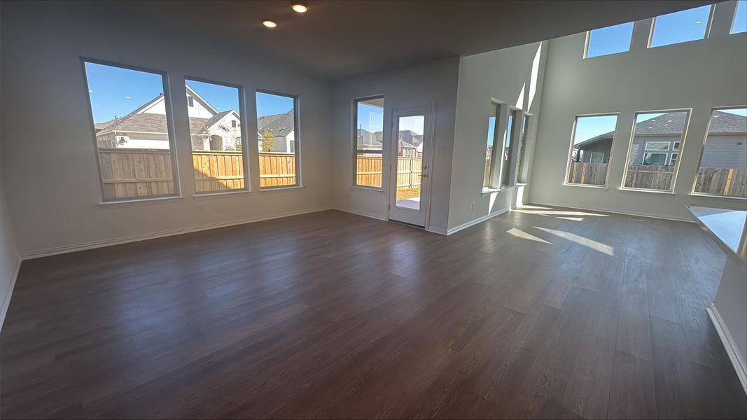 Unfurnished living room with dark wood finished floors and recessed lighting