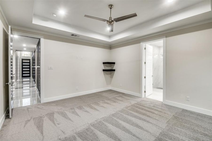 Massif Master bedroom with tray ceilings, shelves and accent wall!