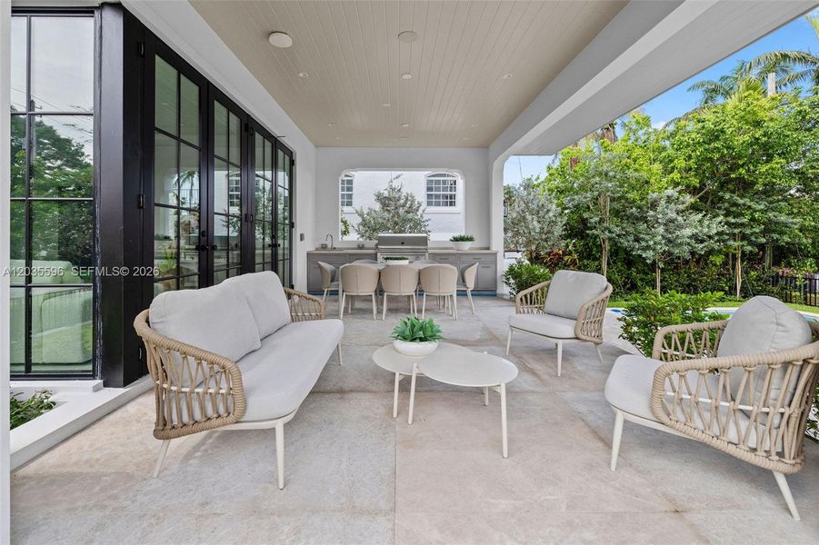 Outside living room with kitchen overlooks pool Outside living room with kitchen overlooks pool