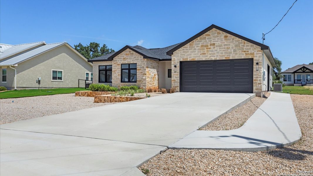 Front exterior of a new home in , Blanco, TX, highlighting curb appeal (Image 28).