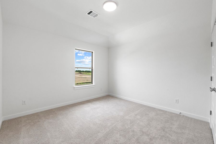 Bedroom in the Pearl home plan by Trophy Signature Homes – REPRESENTATIVE PHOTO