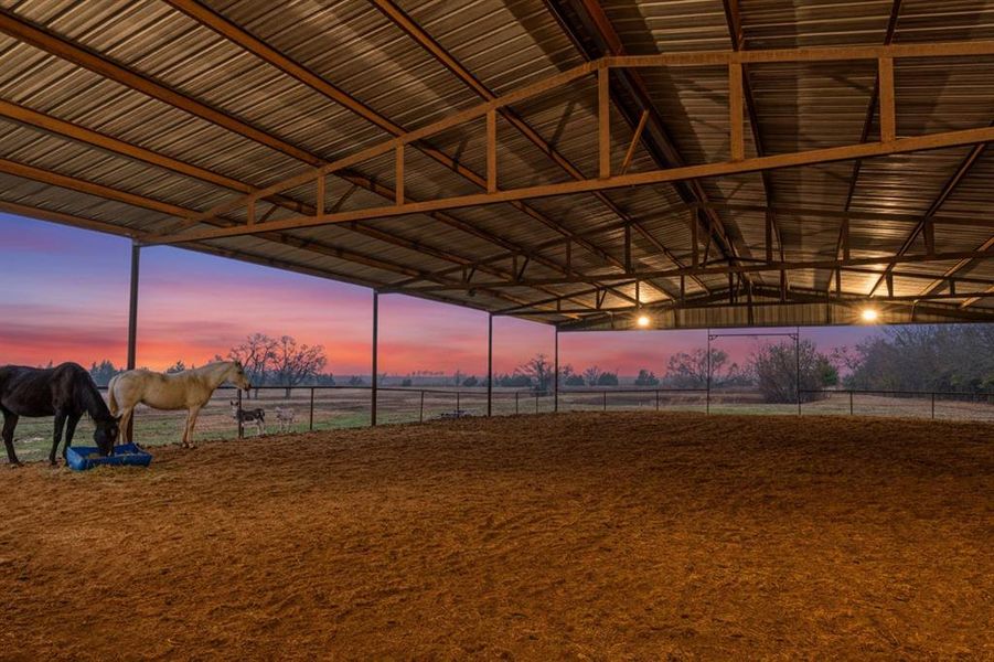 Lighted covered arena with direct access from barn. Lighted covered arena with direct access from barn.