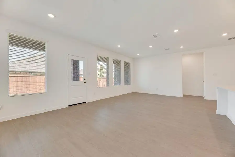 Spare room featuring light wood finished floors and recessed lighting