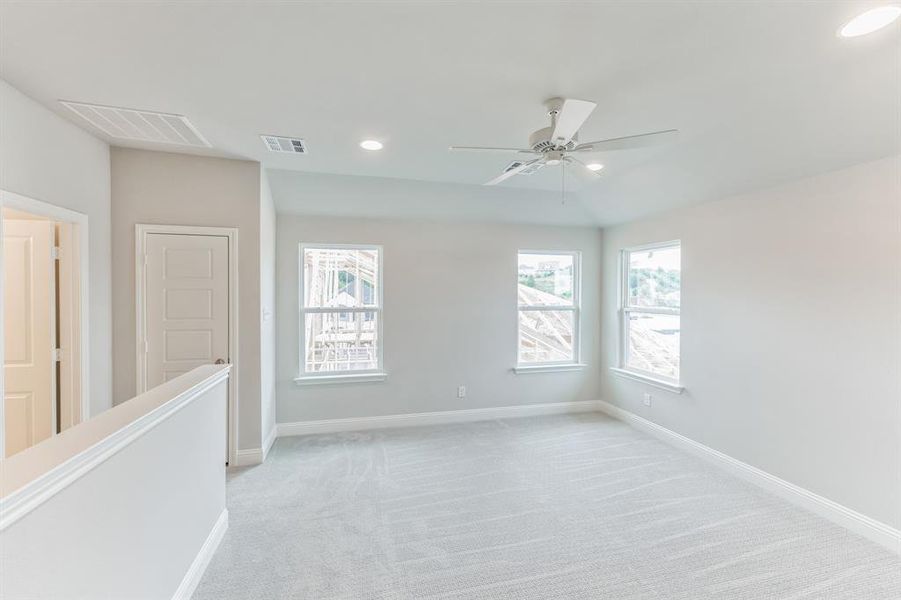 Carpeted empty room with ceiling fan