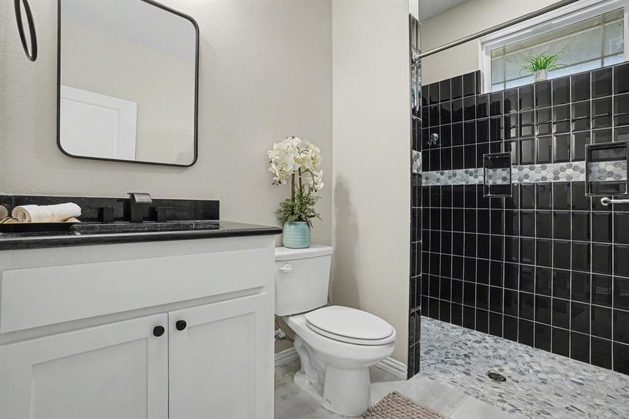 Guest Quarters Bathroom featuring vanity and a tile shower
