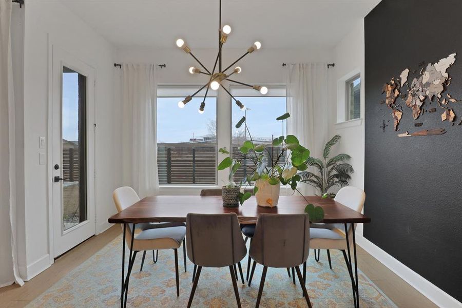 Dining space with accent wall and a chandelier