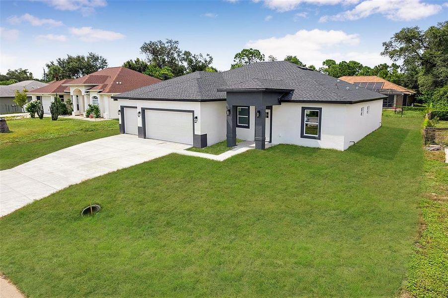 Front exterior of a new home in , North Port, FL, highlighting curb appeal (Image 24). Front exterior of a new home in , North Port, FL, highlighting curb appeal (Image 24).