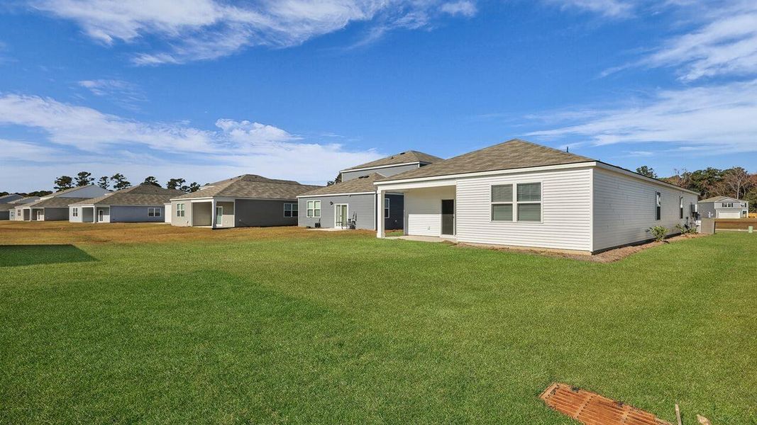 Exterior details and patio area of a home in Pine Hills at Cane Bay, Summerville (Image 21).