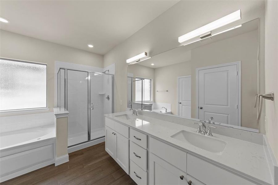 Double vanity with white cabinetry, integrated sinks, and polished chrome fixtures