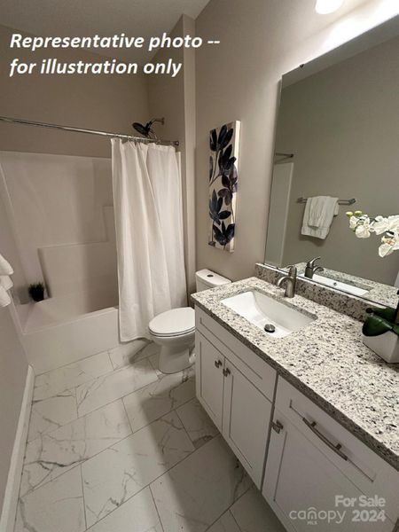 Tile floors and quartz counters in guest bathroom