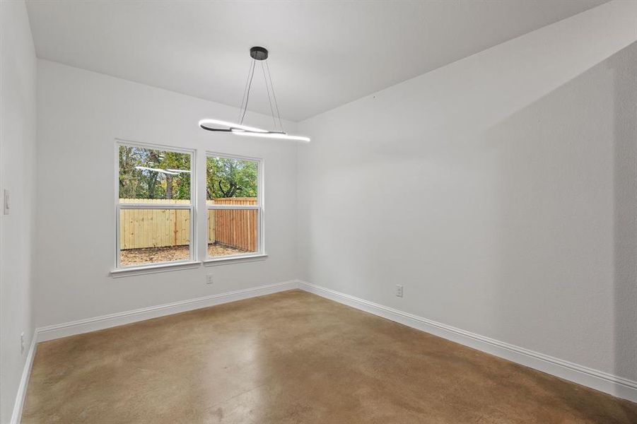 Unfurnished room featuring concrete flooring