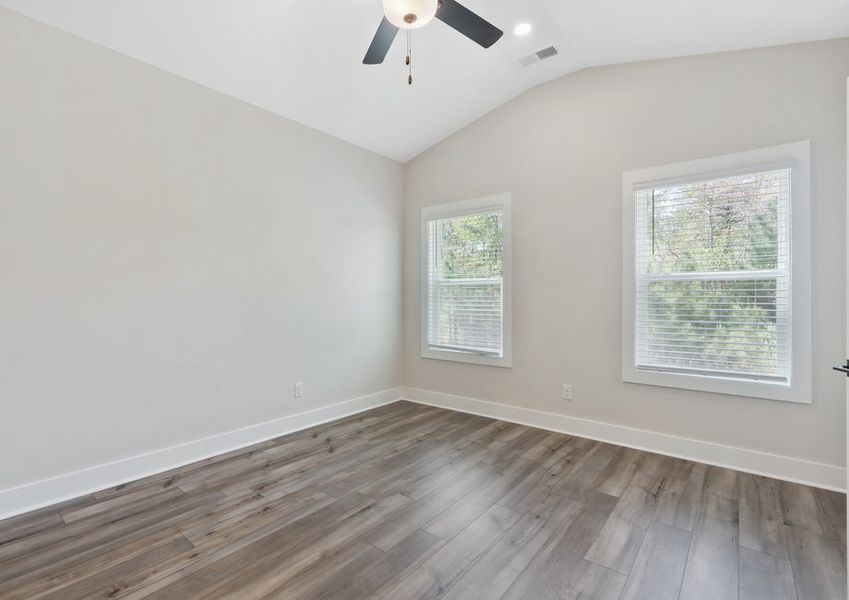 The master bedroom has lots of windows to let in natural light