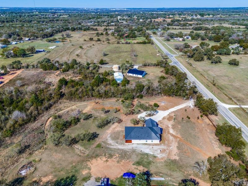 Birds eye view of property featuring a rural view