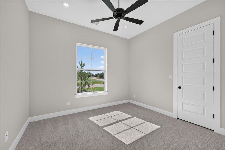 Natural light streams through a large window overlooking the neighborhood.