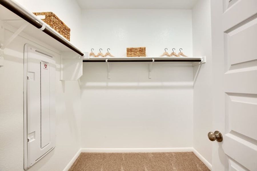 A white room with a shelf and a basket on the wall. A white room with a shelf and a basket on the wall.