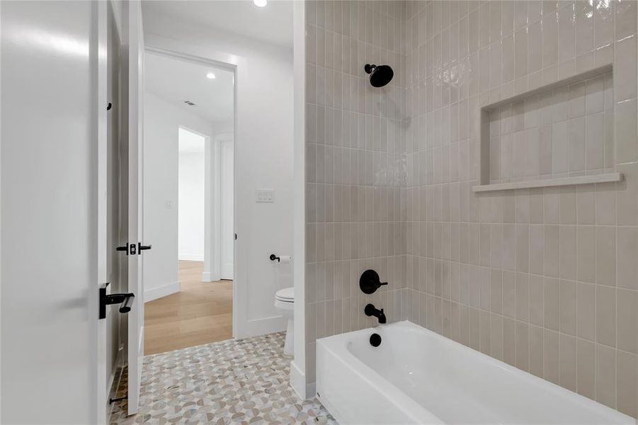 Full bathroom with bathing tub / shower combination and recessed lighting Full bathroom with bathing tub / shower combination and recessed lighting