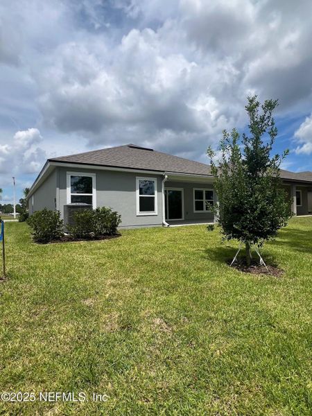 Front exterior of a new home in American Village, Palm Coast, FL, highlighting curb appeal (Image 27).