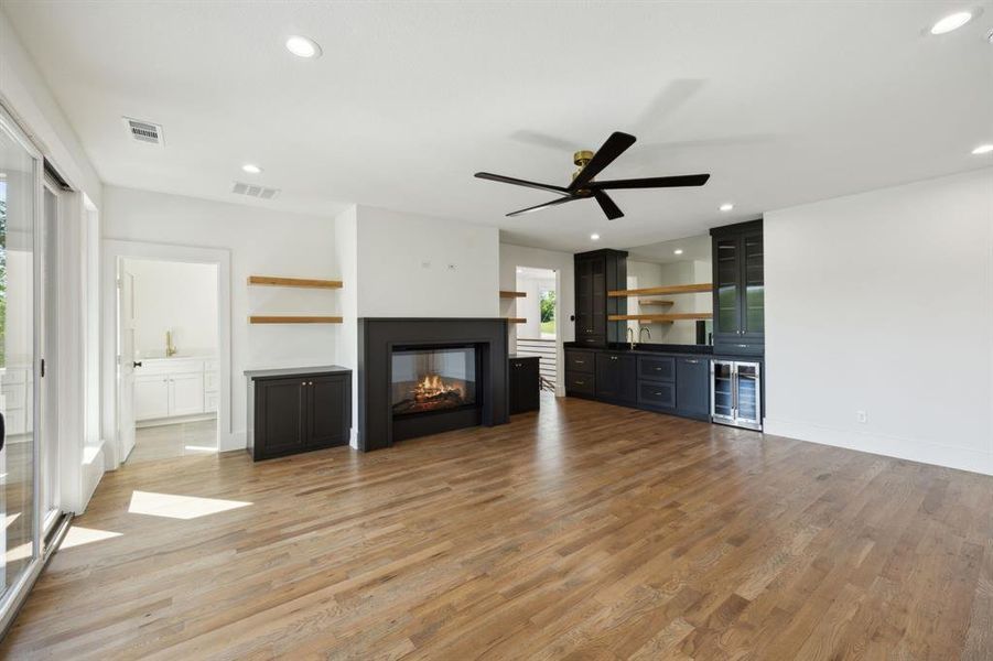 Game room with bar light wood-type flooring, a ceiling fan, visible vents, and recessed lighting Game room with bar light wood-type flooring, a ceiling fan, visible vents, and recessed lighting
