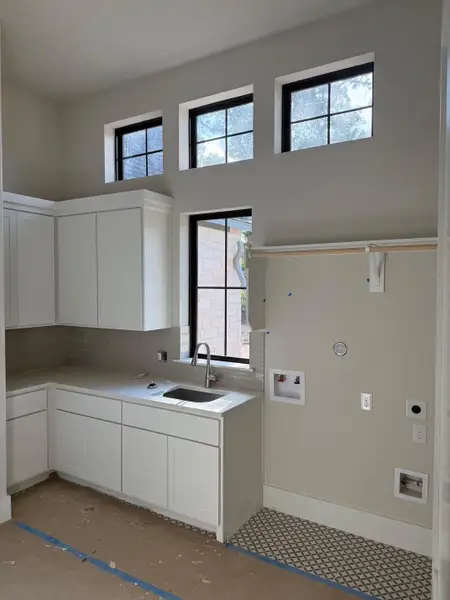 Laundry room with sink, ample storage and hanging space. Laundry room with sink, ample storage and hanging space.