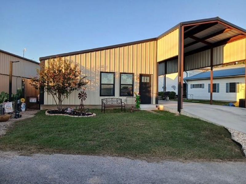 View of home with a carport and driveway