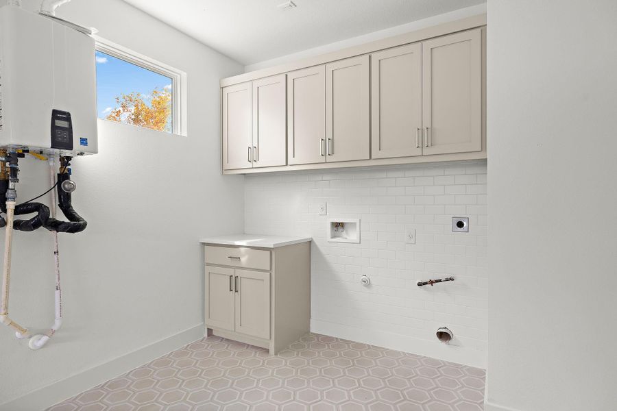 Laundry room in bonus sq ftg off garage.