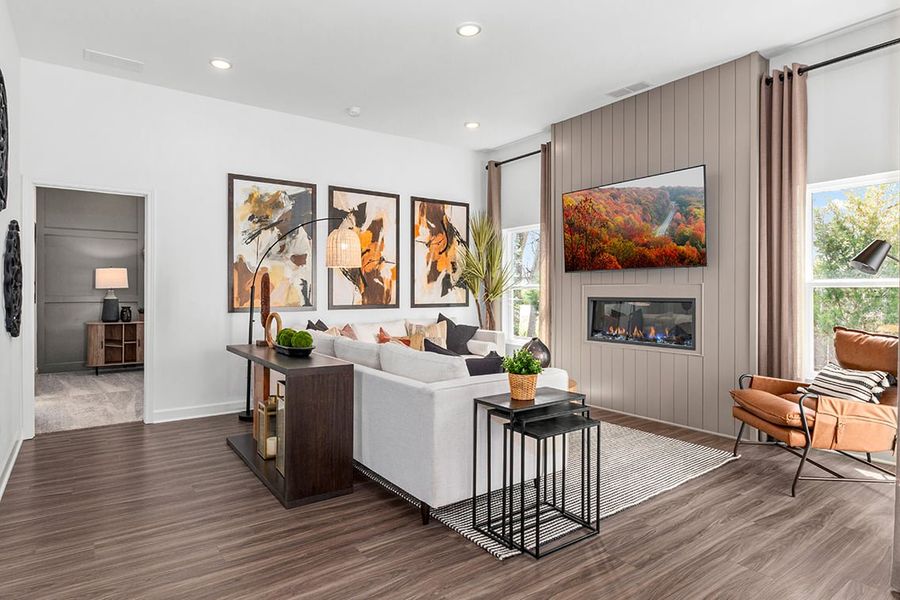 A living room with a white couch and a table with a white couch.