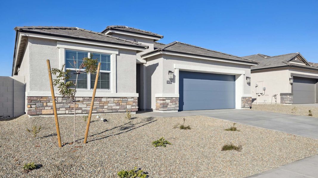 Front exterior of a new home in Desert Moon Estates, Buckeye, AZ, highlighting curb appeal (Image 2).