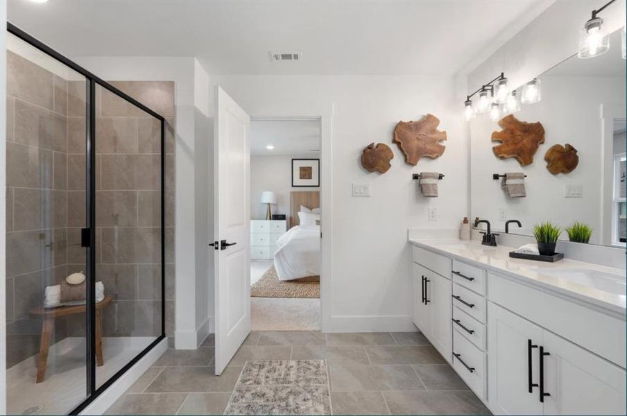 Ensuite bathroom featuring a shower stall, double vanity, tile patterned floors, baseboards, and recessed lighting