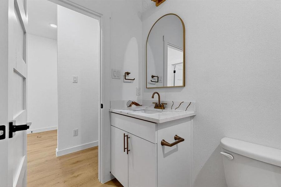 Bathroom featuring vanity and light wood finished floors Bathroom featuring vanity and light wood finished floors