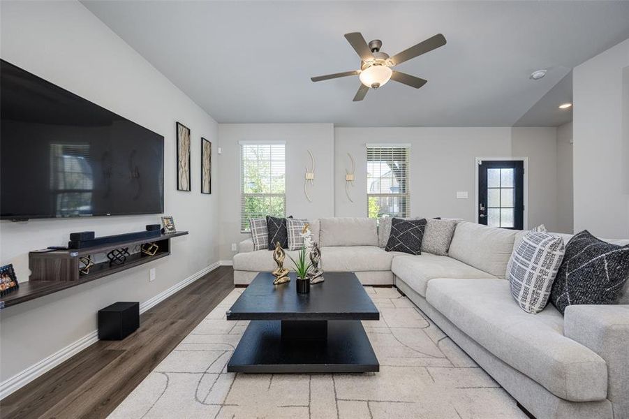 Living area featuring wood finished floors and a ceiling fan Living area featuring wood finished floors and a ceiling fan