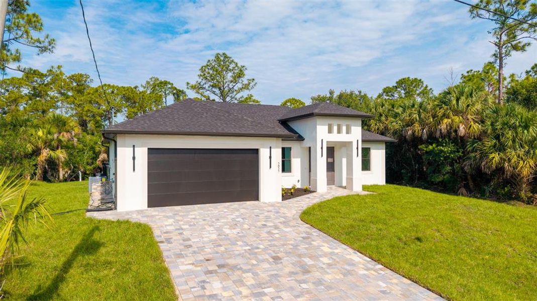 Front exterior of a new home in , North Port, FL, highlighting curb appeal (Image 2). Front exterior of a new home in , North Port, FL, highlighting curb appeal (Image 2).