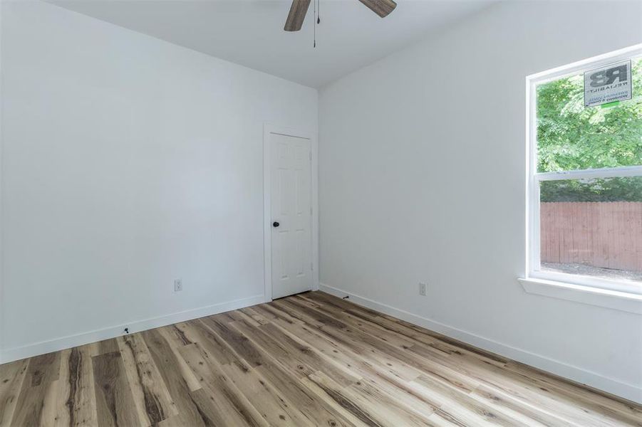 Spare room featuring wood finished floors, a ceiling fan, and baseboards Spare room featuring wood finished floors, a ceiling fan, and baseboards