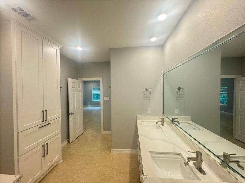 Reverse view of primary bathroom with huge linen closet cabinet space